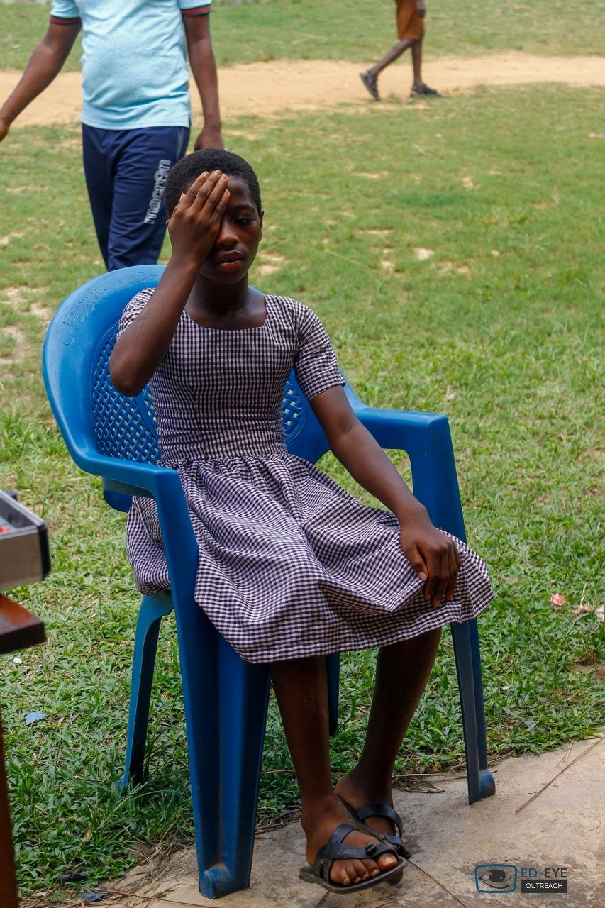 Student covering one eye for a visual acuity assessment