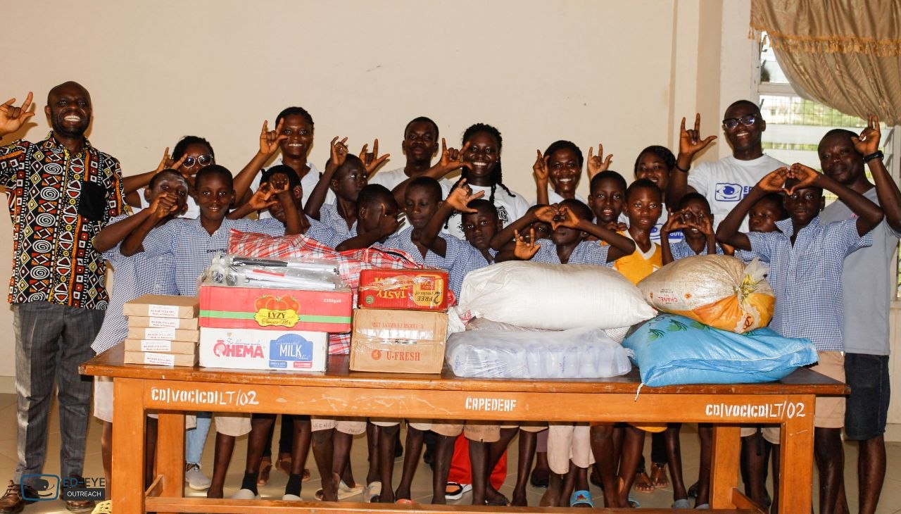 Group posing with donated supplies and outreach representatives