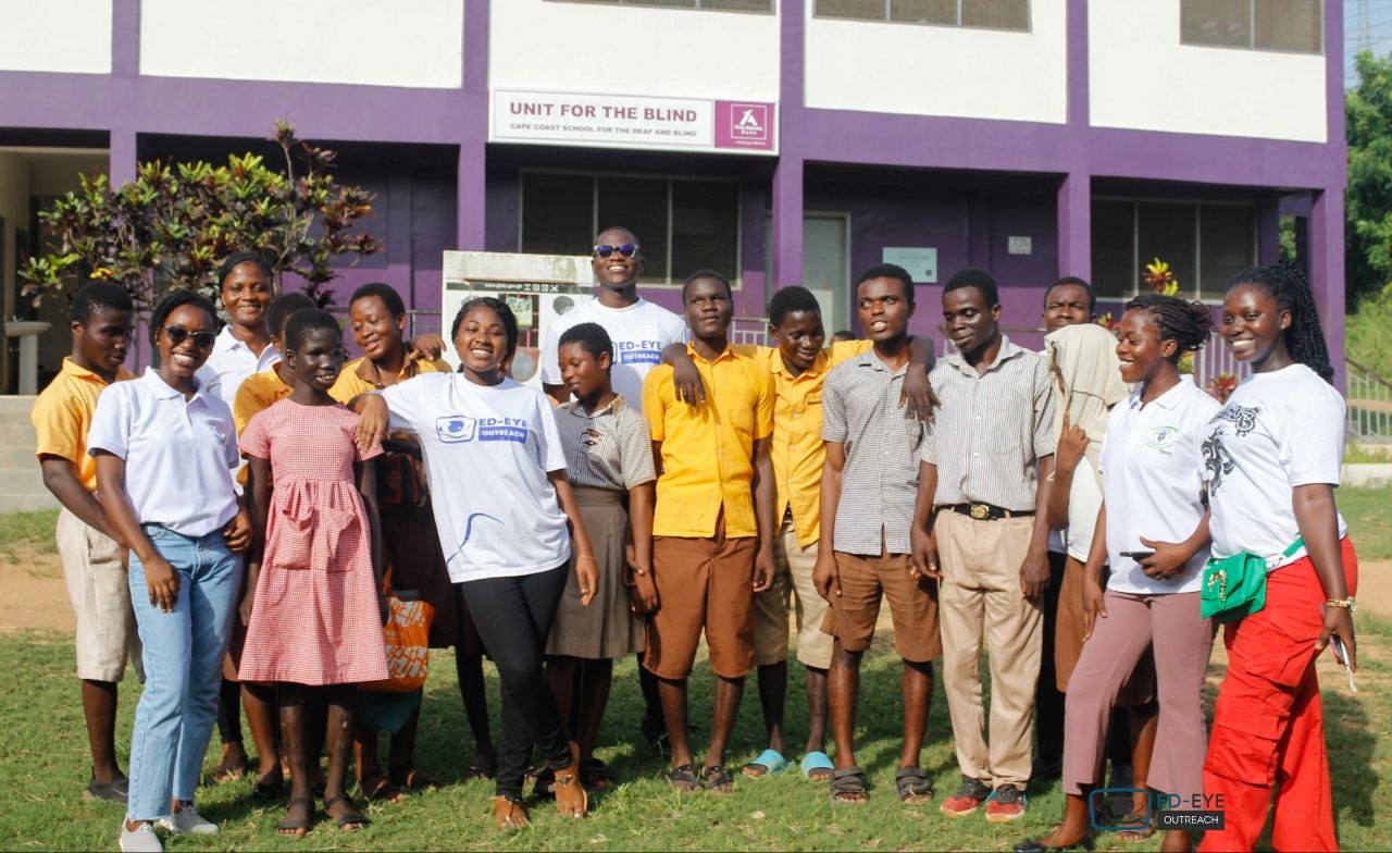 ED-EYE volunteers and school community members posing together outdoors