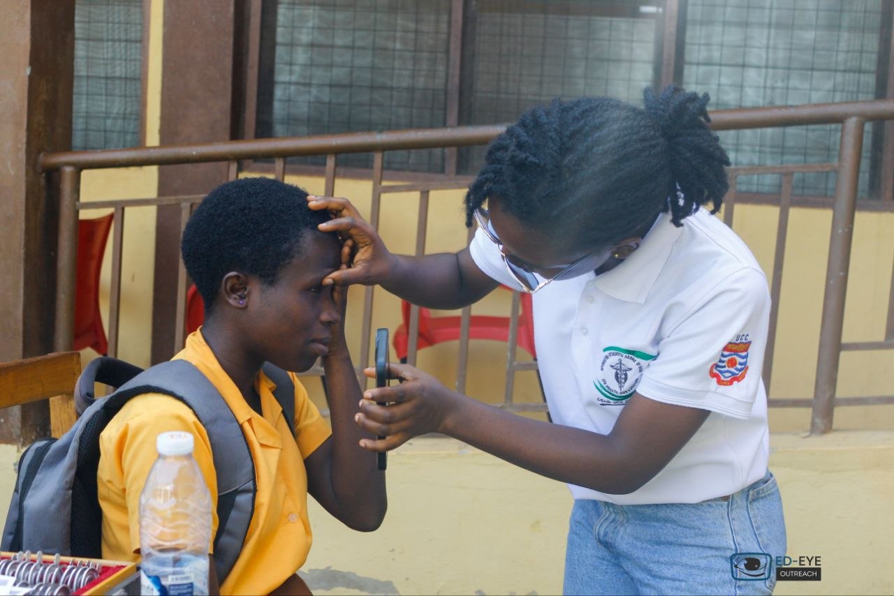 ED-EYE team member examining a student's eye at the school