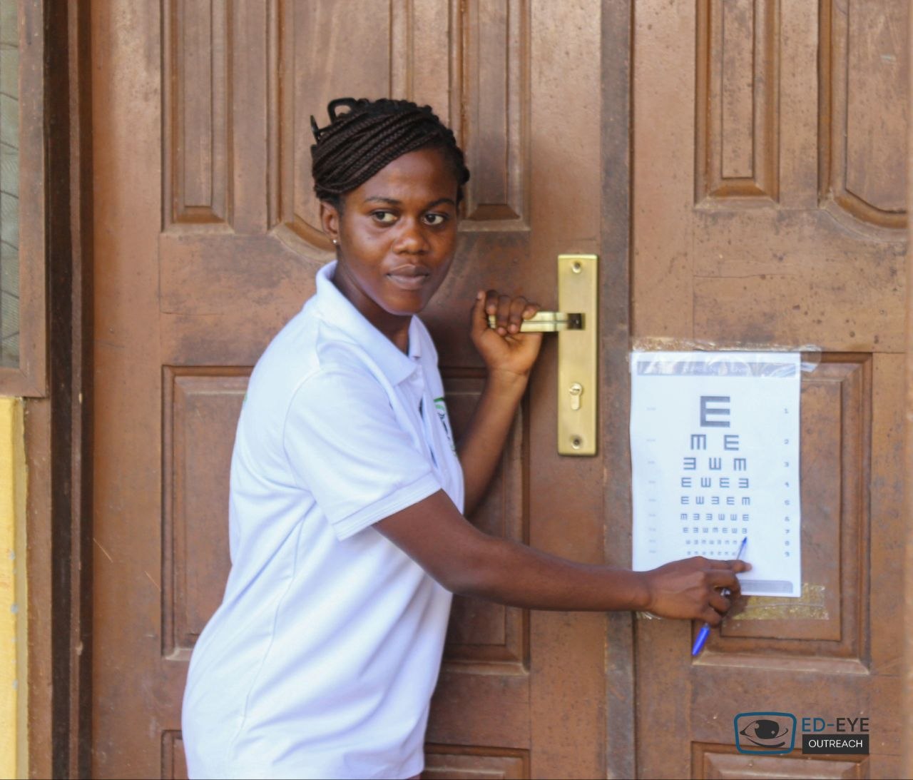 Volunteer indicating letters on an eye test chart